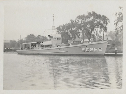 United States Submarine Chaser No. 252 is shown possibly at South Bound Brook in the Delaware and Raritan Canal during the First World War.  The SC252 was a SC-1 Class submarine chaser, a large class of anti-submarine vessels designed at the direction of then-Assistant Secretary of the Navy Franklin D. Roosevelt, who ordered the Navy to design a small, wood-constructed, anti-submarine vessel that could be built quickly in civilian boatyards to combat attacks by German U-boats.  Commissioned on March 7, 1918, the SC252 was 110 feet in length and displaced 85 tons.  She was armed with a 76 mm gun, two .30 caliber Colt machine guns and depth charges.  During World War I, the government used the Delaware and Raritan Canal as a safe corridor to transport boilers and naval supplies to the Brooklyn Navy Yard from Philadelphia and Washington, D.C., while the canal itself was guarded by troops at strategic points.